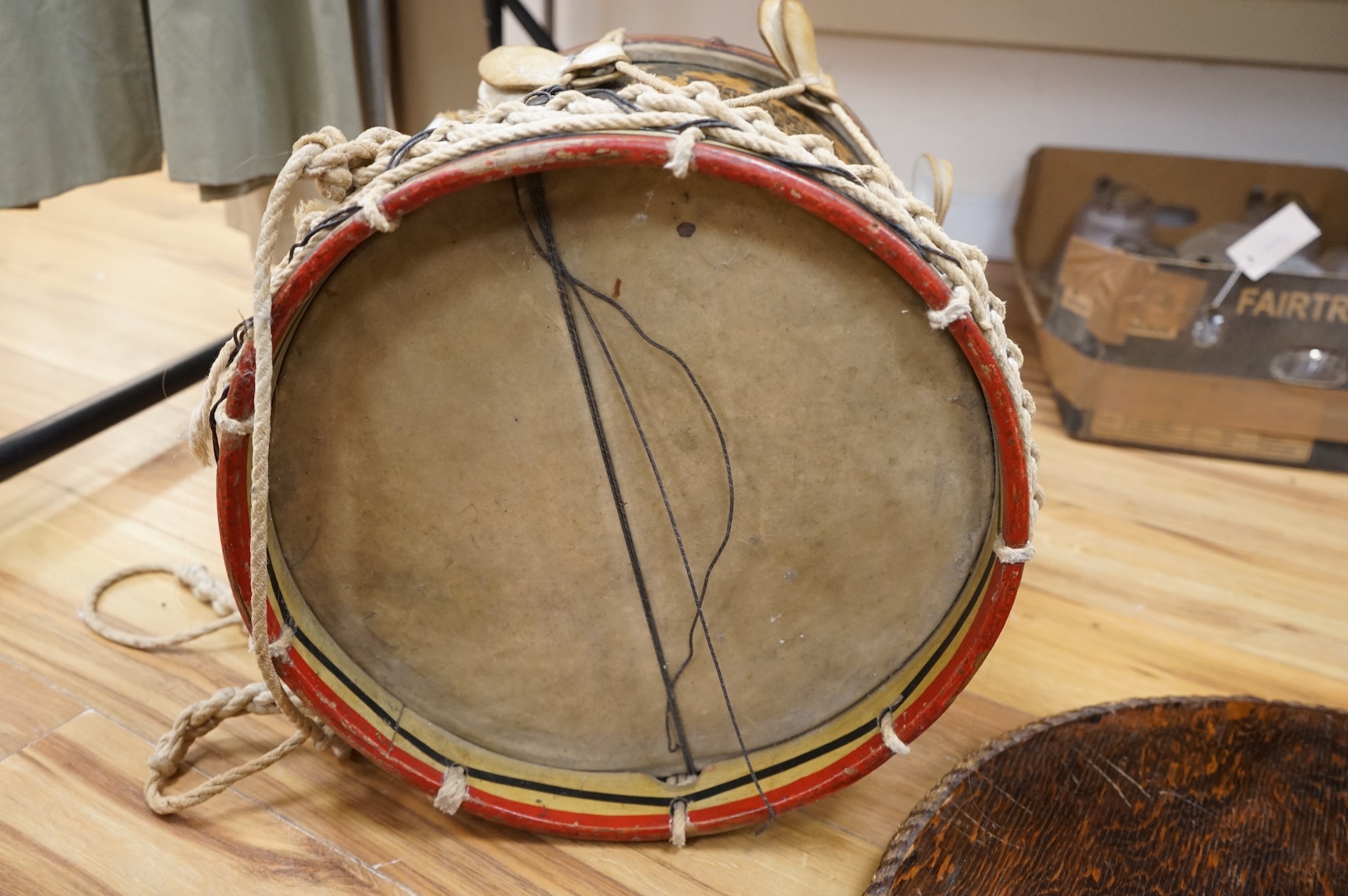 A late 19th/early 20th century Royal East Kent Regiment 'Buffs' regimental drum, 37cm diameter, 37cm high, together with a rope edged, stained pine removable 'table top' adaption